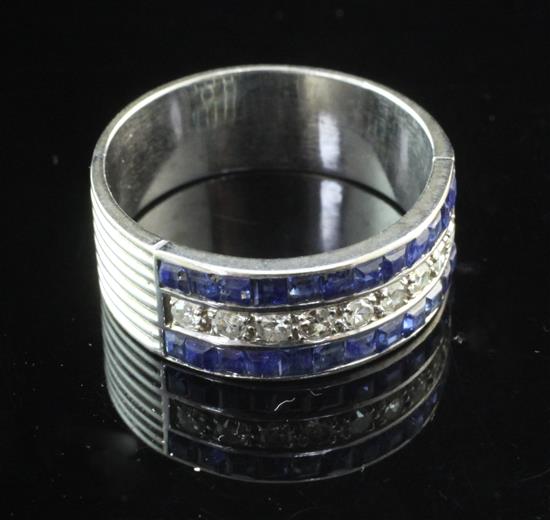 A platinum, sapphire and diamond channel set triple band half hoop ring, size U.